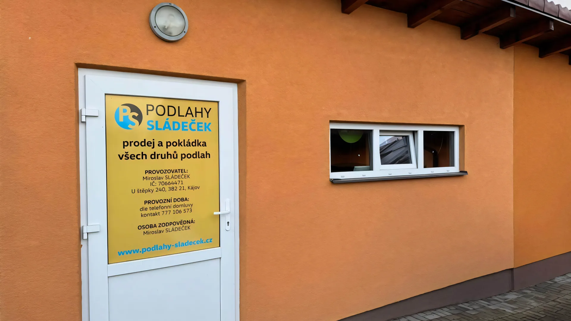 Vstup do vzorkovny Podlahy Sládeček v Kájově s cedulí firmy